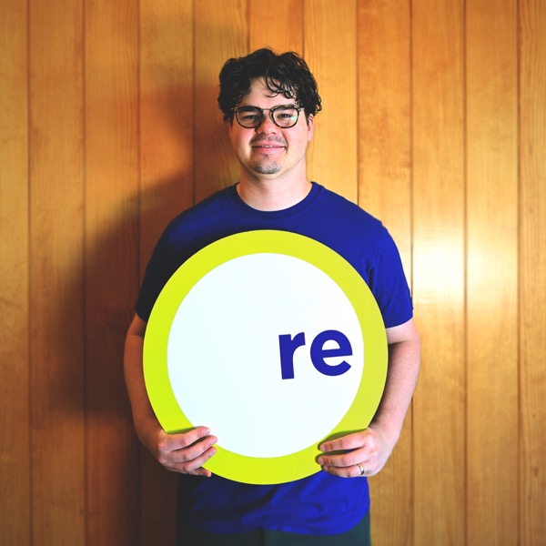 Jake, team member, holding a REdesign.build sign
