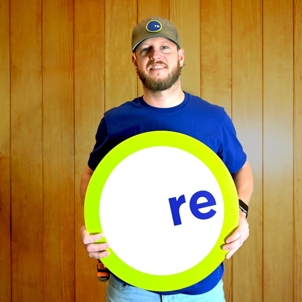 Peter, team member, holding a REdesign.build sign